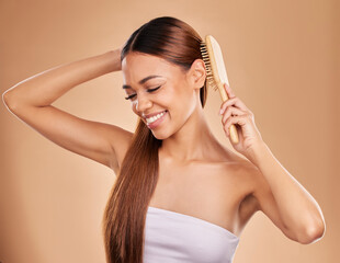 Wall Mural - Smile, beauty and woman brushing hair for growth and shine for healthy texture on brown background. Aesthetic female model happy in studio with a brush for natural keratin treatment haircare results