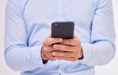 Poster - Business man, hands and typing with phone in studio isolated on a white background. Cellphone, networking and male professional with smartphone for texting, social media or internet browsing online.