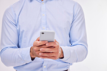 Canvas Print - Hands, business man and typing with phone in studio isolated on a white background. Cellphone, networking and male professional with smartphone for texting, social media or internet browsing online