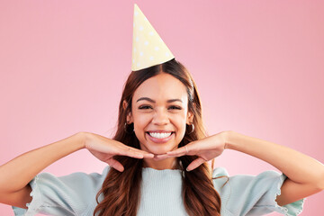 Wall Mural - Birthday woman, face portrait and smile for happy celebration event, congratulations or celebrate happiness. Studio posing, party hat and headshot female, person or young model on pink background