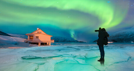 Wall Mural - northern lights (aurora borealis) in the sky over tromso, norway - aurora reflection on the sea on t