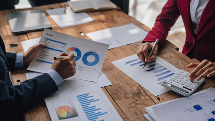 Wall Mural - Team of lawyers and tax auditors brainstorming together and calculating the balance sheet and historical financial accounts of the company and shareholders. to detect mistakes and prevent bribery