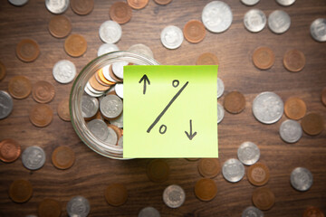 Wall Mural - Percentage symbol on sticky note with a coins.