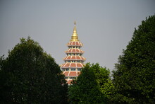 Looking Through The Large Bushes, A 9-tiered Pagoda Can Be Seen Located At "Wat Huai Pla Kung", Muang District, Chiang Rai Province. Each Floor Of The Pagoda Have The Enshrined Sacred
