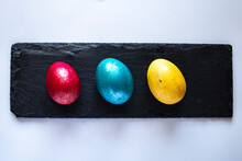Colorful Easter Eggs 
On A Black Stone Surface.