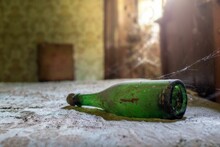 Closeup Shot Of A Dirty Bottle In An Abandoned And Lost Place