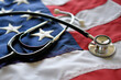 © MargJohnsonVA - United States America healthcare medical concept - stethoscope on American flag