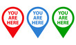Icono puntero de ubicación con texto You Are Here en varios colores