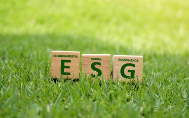 Words ESG on a wood block on the lawn and Future environmental conservation and sustainable ESG modernization development by using the technology of renewable resources to reduce pollution and carbon 