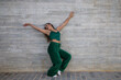 © @skuder_photographer - Latin woman, young and beautiful dancing modern dance on a background of gray cement in the street makes different expressions and postures. Concept dance, hip hop, dance, art, action, youth art.