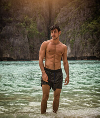 Handsome young man standing on a beach in Phuket Island, Thailand