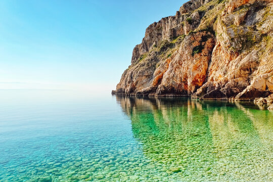 Wall Mural - Calm lagoon and wild beach with azure water on a sunny day. Island Cres, Croatian coast, Europe.