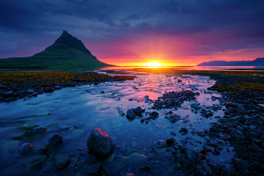 Wall Mural - An incredible view of the famous peak of the Kirkjufell volcano at dawn. Iceland, Europe.