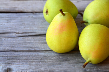 Wall Mural - Fresh ripe organic pears on old wooden background.Pear fruits on a rustic table.Healthy eating,diet,raw food and nutrition or harvest concept.
Selective focus.