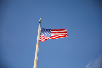 Wall Mural - US flag depicting historic freedom and american pride along with independence of fourth of july and patriotism on a national level in the sky and home