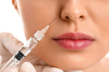 Sticker - Young woman receiving filler injection in face, closeup