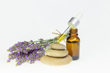 Wall Mural - Amber essential lavender oil bottle. Pipette with drop and bottle on an isolated background.