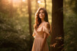 © aicandy - Radiant beauty posing in a flowy dress with a serene forest background and soft golden hour light, generative ai