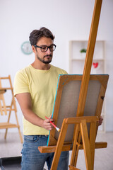 Canvas Print - Young man enjoying painting at home