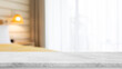 © bunditinay - Empty white marble stone table top and blurred living room at home interior with window curtain background. - can used for display or montage your products.