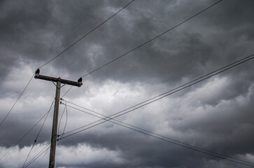 electricity pole with cloudy and storm background