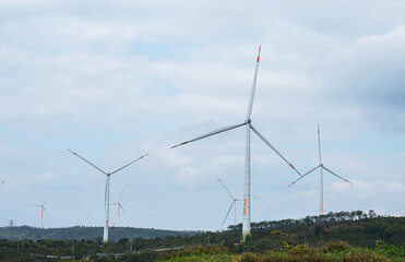 Wall Mural - Wind generator turbines at wind farm. Alternative energy concept.