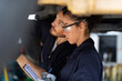 © NVB Stocker - Hispanic Female trainee Mechanics Working Underneath Car Together Car maintenance and auto service garage. Car maintenance and auto service garage concept.