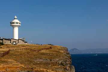 Wall Mural - white lighthouse and blue sky