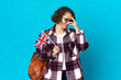 © luismolinero - Young English woman holding an United Kingdom flag isolated on blue background laughing