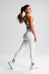 fitness woman. athletic girl on the gray background