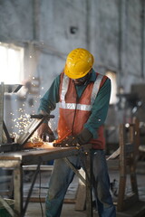 Working with Power Tools - Stock photo of Man Using Angle Grinder with Sparks Flying, Man using angle grinder sparks, Worker cutting metal with grinder
