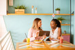 © BGStock72 - Young black and caucasian woman having good time, drinking fresh juices and having healthy breakfast in the cafe