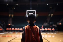 A Black Child With Their Back Turned, Wearing Sports Clothing, Looks At A Basketball Hoop In A Basketball Court Concept: Chasing Your Dreams