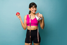 Fitness Latin Woman On A Diet Eating Chocolate