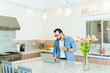 © AntonioDiaz - Handsome man working on the laptop in his luxury kitchen