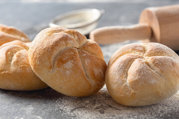Aufkleber - Set of small bun bread on the dark table with rolling pin. Fresh home baking concept