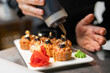 © pavel siamionov - professional chef's hands making sushi and rolls in a restaurant kitchen