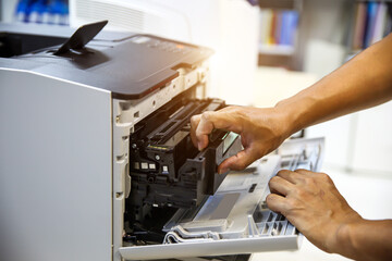 Technician hand open cover printer photocopier or photocopy to replace ink cartridges or fix paper jam for scanning fax or copy document in office workplace.