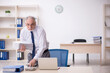 © Elnur - Old male employee working in the office