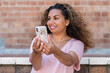 © Austockphoto - indigenous woman taking selfie with mobile phone