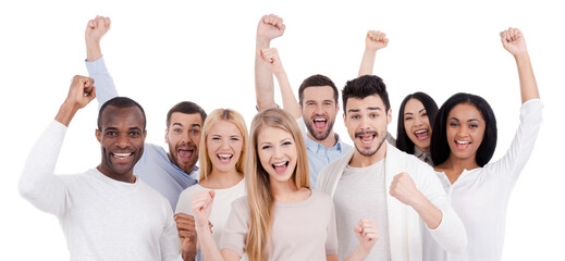 Wall Mural - Group of happy young people looking at camera and gesturing against white background