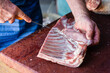 © Austockphoto - mobile butcher cutting up lamb meat