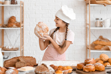 Poster - Little baker with fresh bread in kitchen