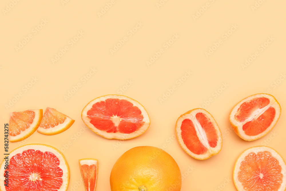 Composition with pieces of ripe grapefruit on color background