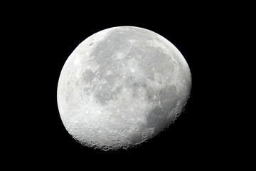 Wall Mural - closeup shot of the moon shining bright in the dark night sky for backgrounds and wallpapers