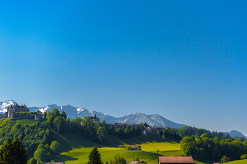 Wall Mural - Castle of Gruyeres among forest and greend meadows in Haut-Intyamon, Gruyere, Fribourg, Switzerland