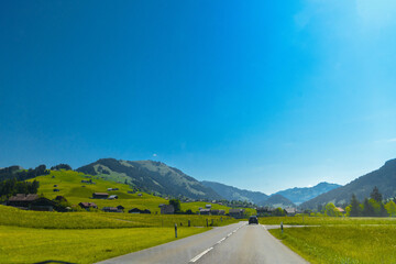 Wall Mural - Road and green meadows, Gruyere, Fribourg Switzerland