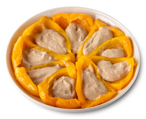 Wall Mural - Cooked yellow peppers stuffed with Bagna caoda sauce, a cream made with anchovies, garlic, olive oil typical of Piedmont, Italy in white plate