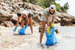 Female Volunteer Cleaning Sea Beach From The Trash