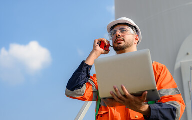 Professional engineer technician team working at wind turbine farm field